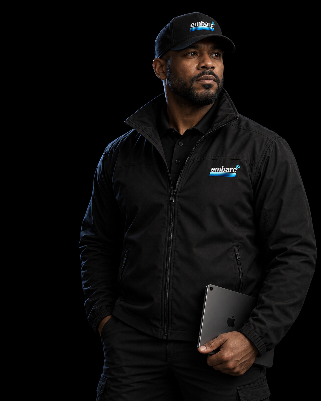 Embarc field operator in branded gear holding a tablet